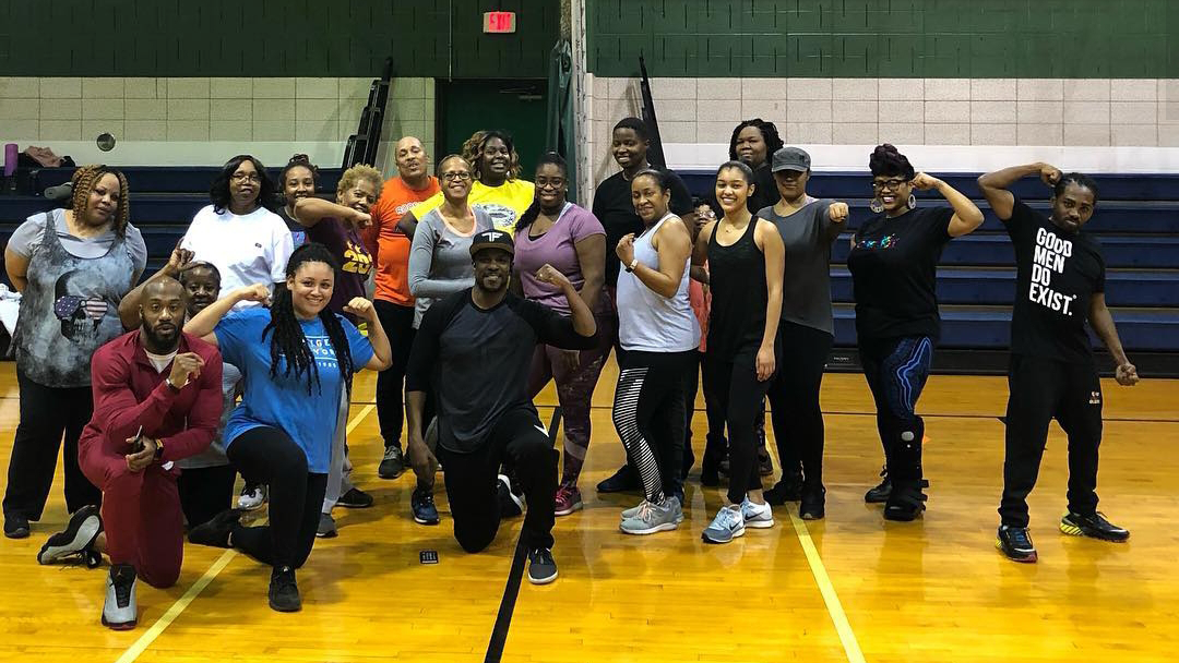 A group of people pose for a photo after exercise class